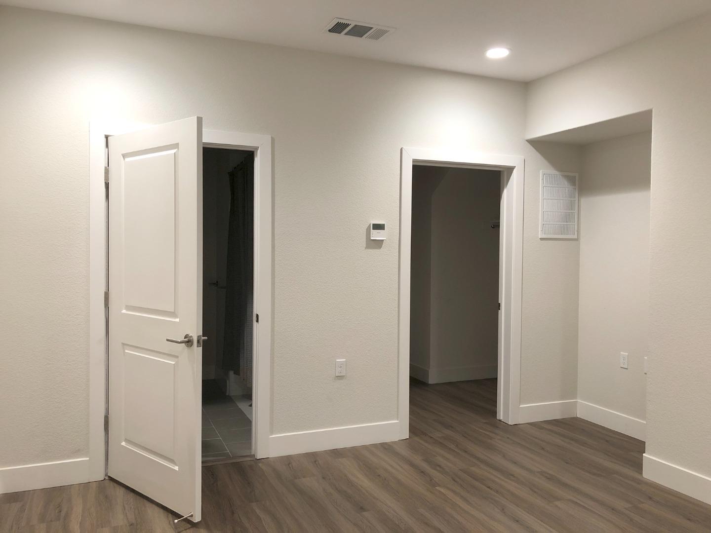 215 Houret Drive Milpitas, CA 95035 - Photo 10 of 14 an empty room with wooden floor and closet