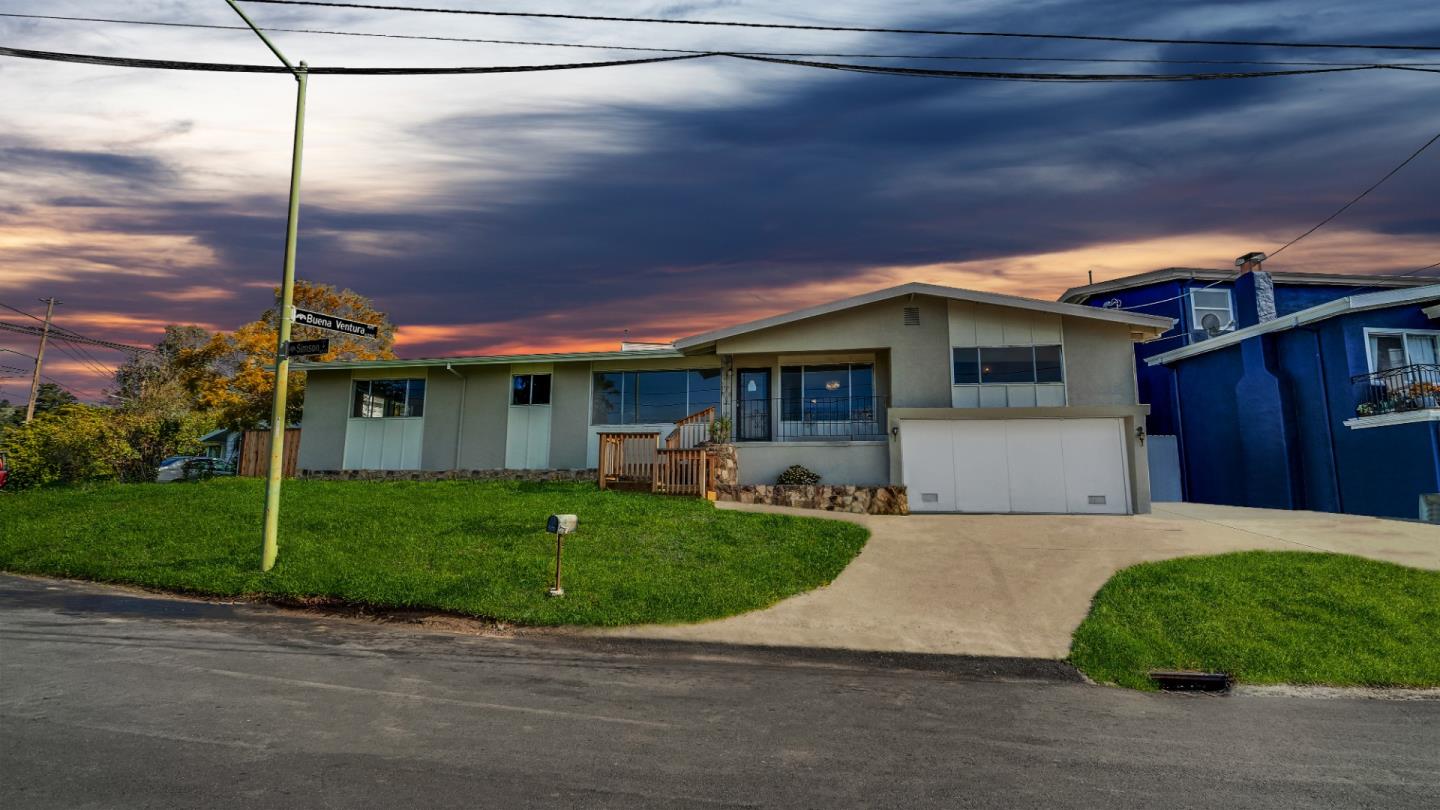 a front view of a house with garden