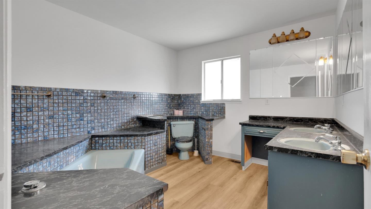 6530 Simson Street Oakland, CA 94605 - Photo 11 of 14 a kitchen with a stove a sink and a microwave