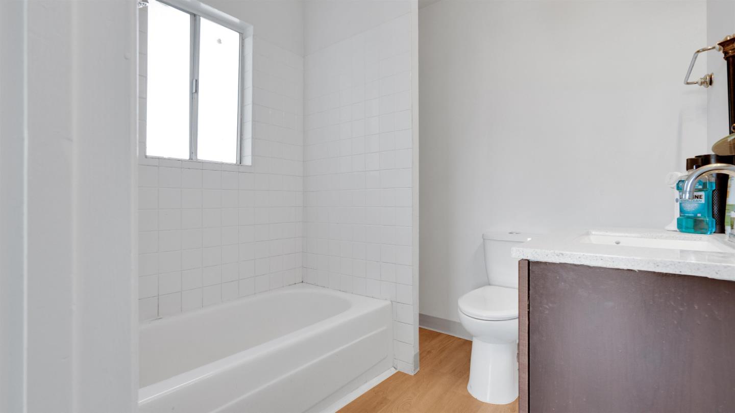 6530 Simson Street Oakland, CA 94605 - Photo 12 of 14 a bathroom with a sink a toilet and bathtub