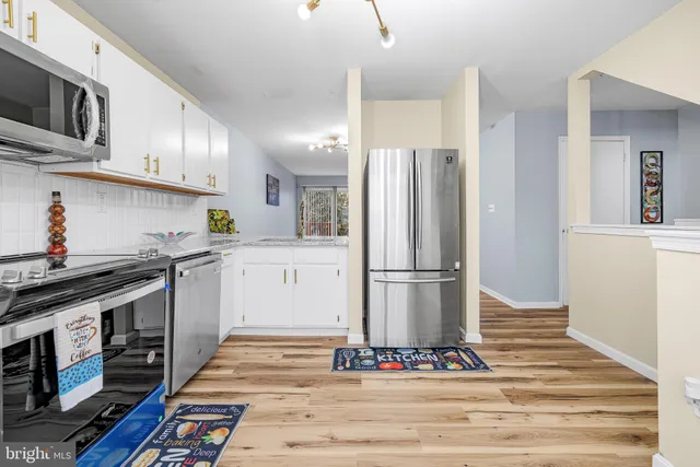 a kitchen with stainless steel appliances a refrigerator stove and sink