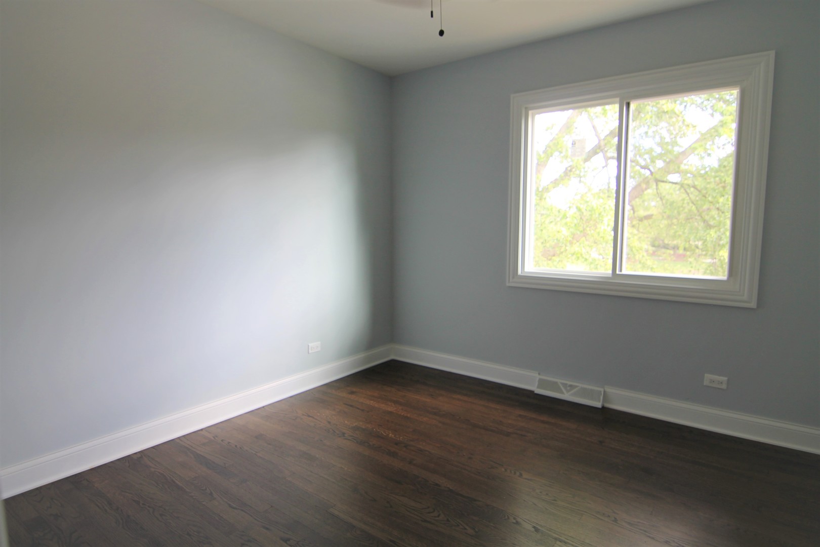 1112 Lake Cook Road Deerfield, IL 60015 - Photo 21 of 31 an empty room with wooden floor and a window