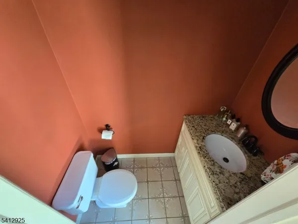 a bathroom with a sink mirror vanity and a toilet
