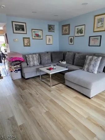 a living room with a couch and paintings on the wall