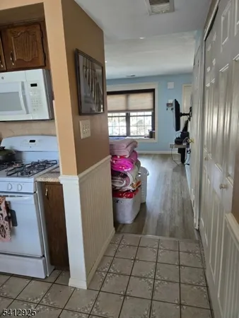 a dining room with furniture and a floor to ceiling window