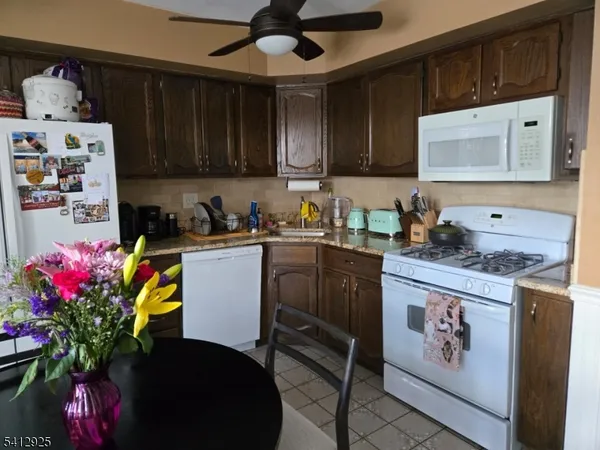 a kitchen with stainless steel appliances granite countertop a sink dishwasher stove and cabinets