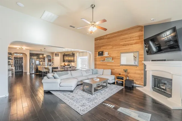 a living room with furniture fireplace and flat screen tv