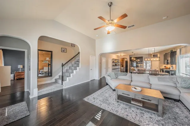 a living room with couch and wooden floor