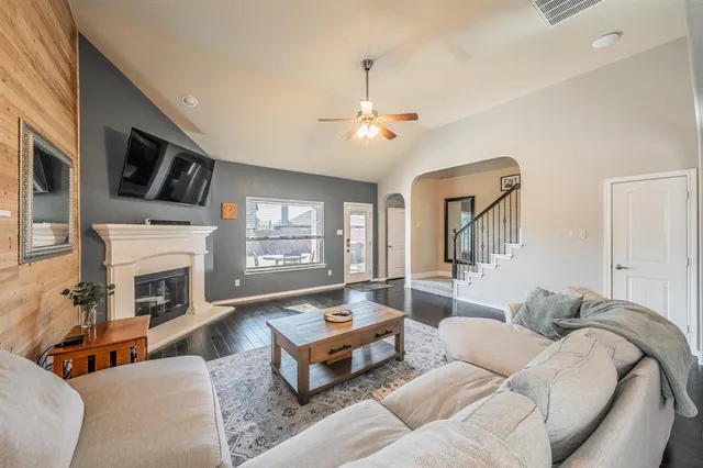 a living room with furniture fireplace and a flat screen tv