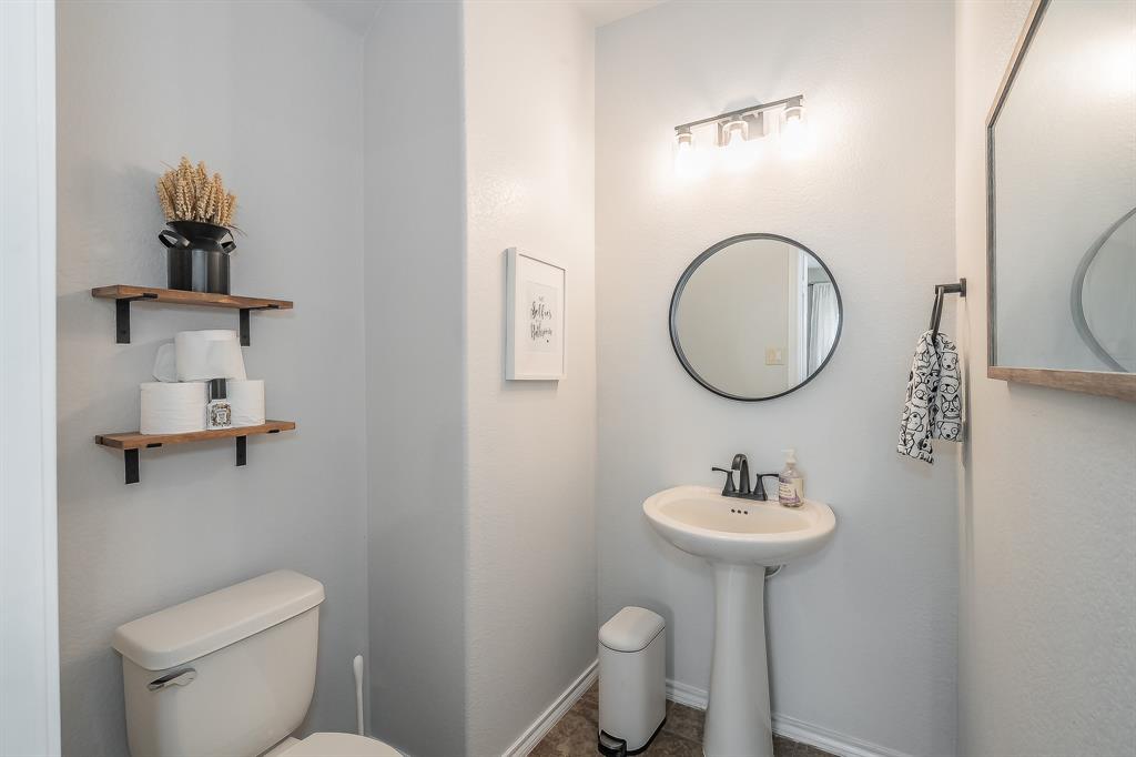 10417 Boxthorn Court Fort Worth, TX 76177 - Photo 15 of 40 a bathroom with a toilet sink and mirror