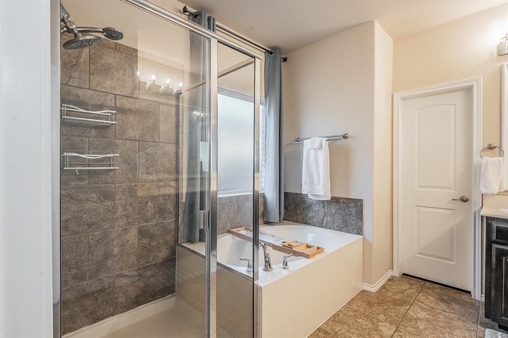 10417 Boxthorn Court Fort Worth, TX 76177 - Photo 17 of 40 a bathroom with a tub and shower