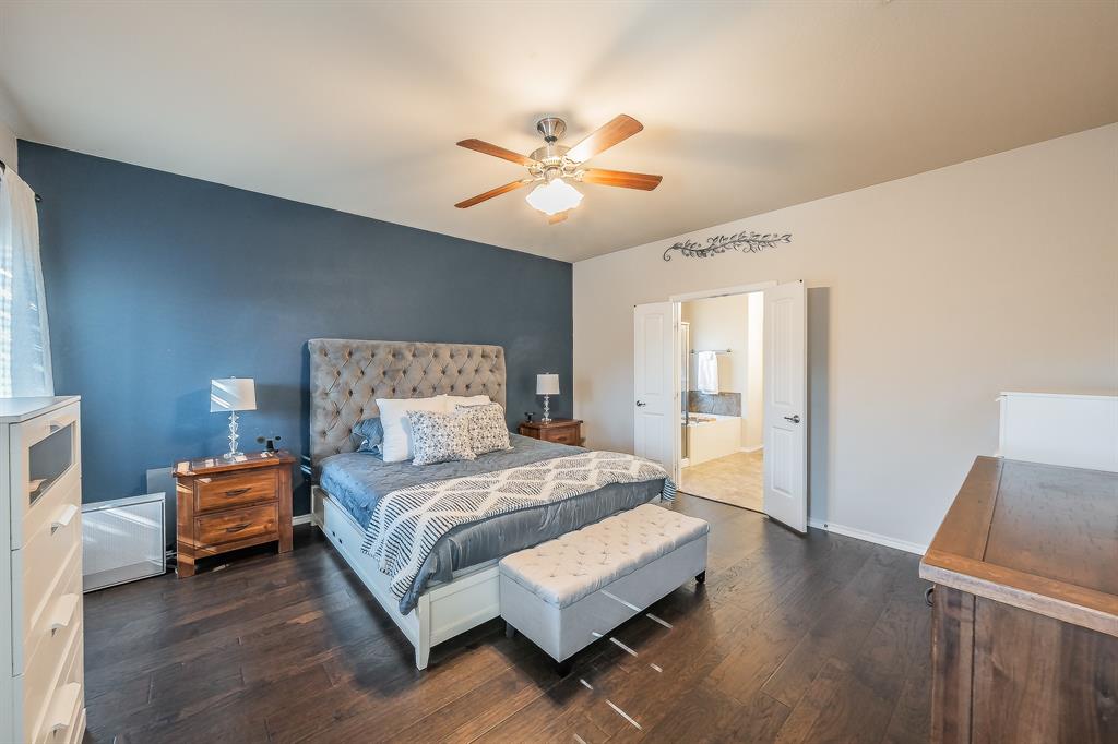 10417 Boxthorn Court Fort Worth, TX 76177 - Photo 18 of 40 a spacious bedroom with a bed and a chandelier