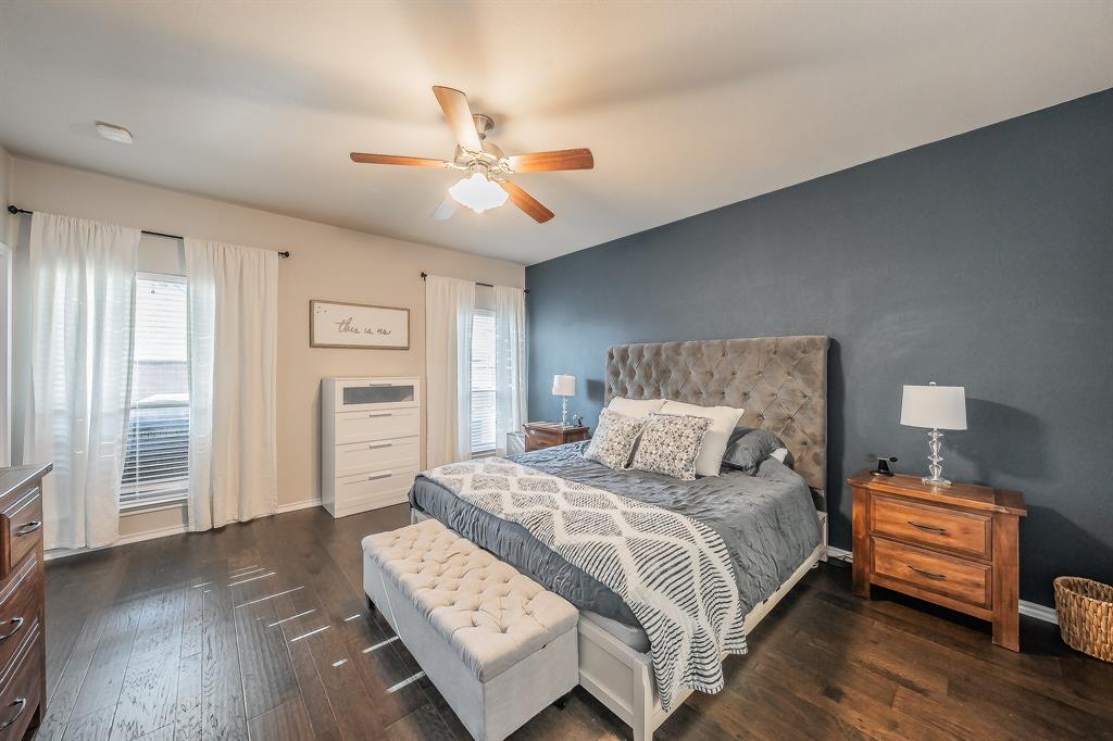 10417 Boxthorn Court Fort Worth, TX 76177 - Photo 20 of 40 a bedroom with a bed and wooden floor