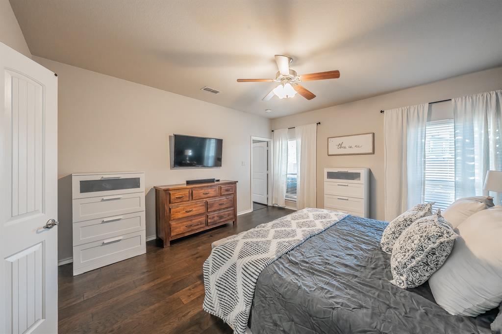 10417 Boxthorn Court Fort Worth, TX 76177 - Photo 21 of 40 a bedroom with a bed and wooden floor