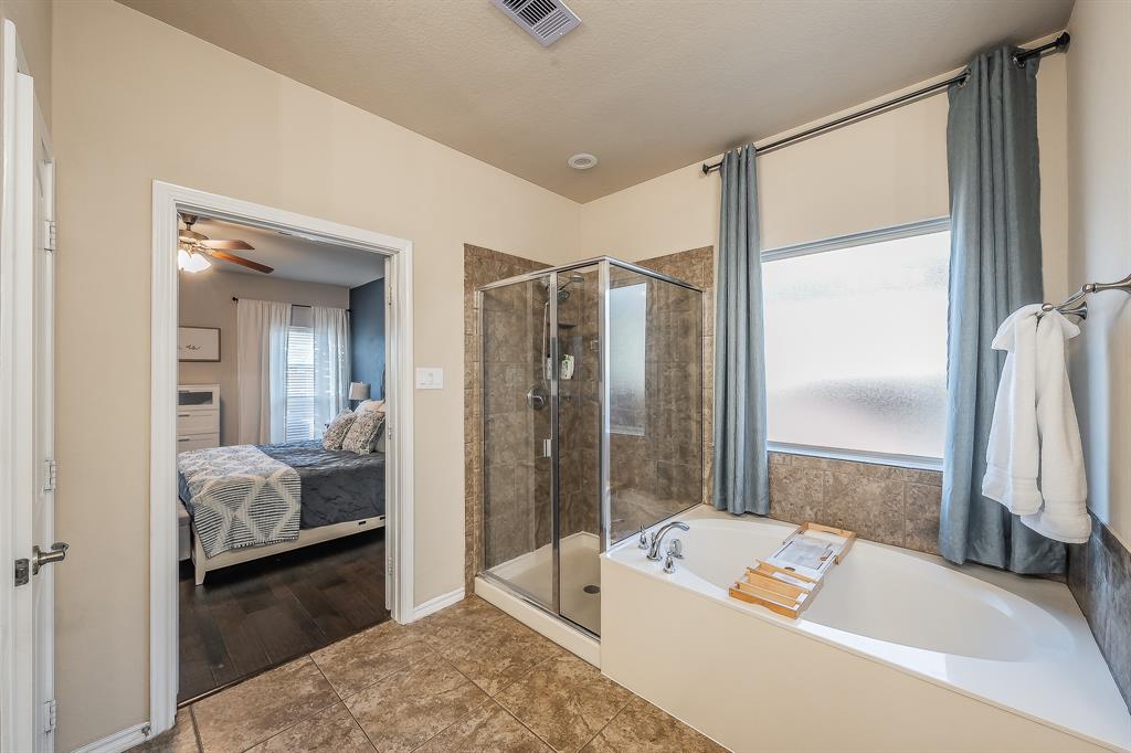 10417 Boxthorn Court Fort Worth, TX 76177 - Photo 22 of 40 a bathroom with a tub shower and a sink
