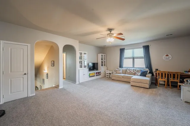 a view of a livingroom with furniture and a flat screen tv