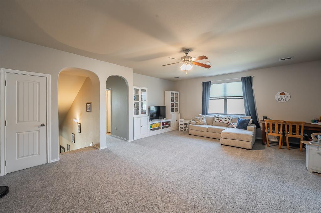 10417 Boxthorn Court Fort Worth, TX 76177 - Photo 25 of 40 a living room with furniture and a chandelier