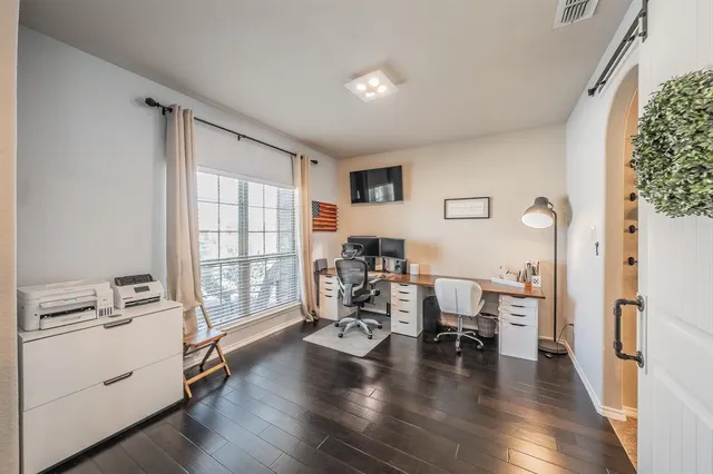 a view of a livingroom with furniture hardwood floor and a window