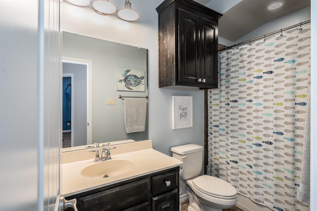 10417 Boxthorn Court Fort Worth, TX 76177 - Photo 37 of 40 a bathroom with a sink a toilet and shower