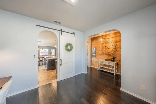 a view of a livingroom with wooden floor and a window