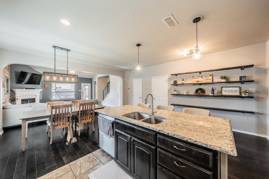 10417 Boxthorn Court Fort Worth, TX 76177 - Photo 6 of 40 a kitchen with stainless steel appliances granite countertop a stove and a wooden floors