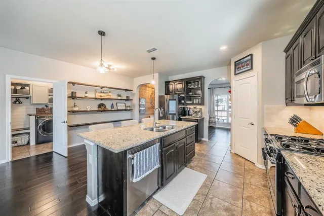 a kitchen with stainless steel appliances granite countertop a stove oven and a refrigerator