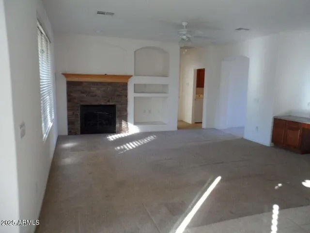 a view of an empty room with a fireplace