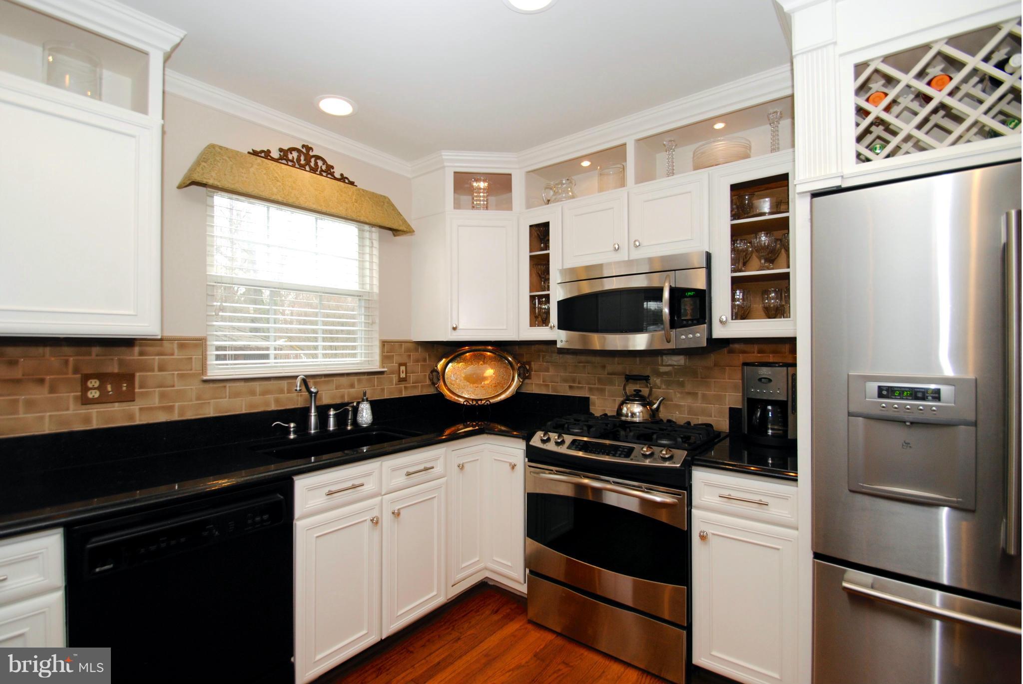 520 Broadwater Road Arnold, MD 21012 - Photo 13 of 30 Custom Cabinetry with Downlighting and Wine Rack