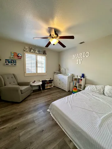 a bedroom with furniture and a large window