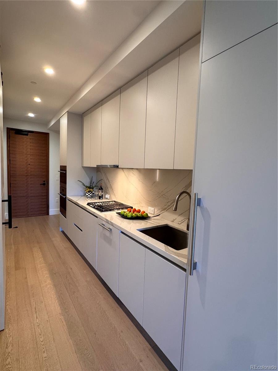 1901 Wazee Street, Unit 412 Denver, CO 80202 - Photo 27 of 33 a kitchen with a cabinets and white appliances