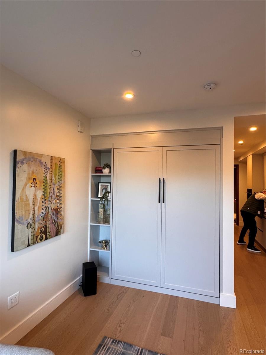 1901 Wazee Street, Unit 412 Denver, CO 80202 - Photo 29 of 33 a view of a hallway with wooden floor and a cabinet
