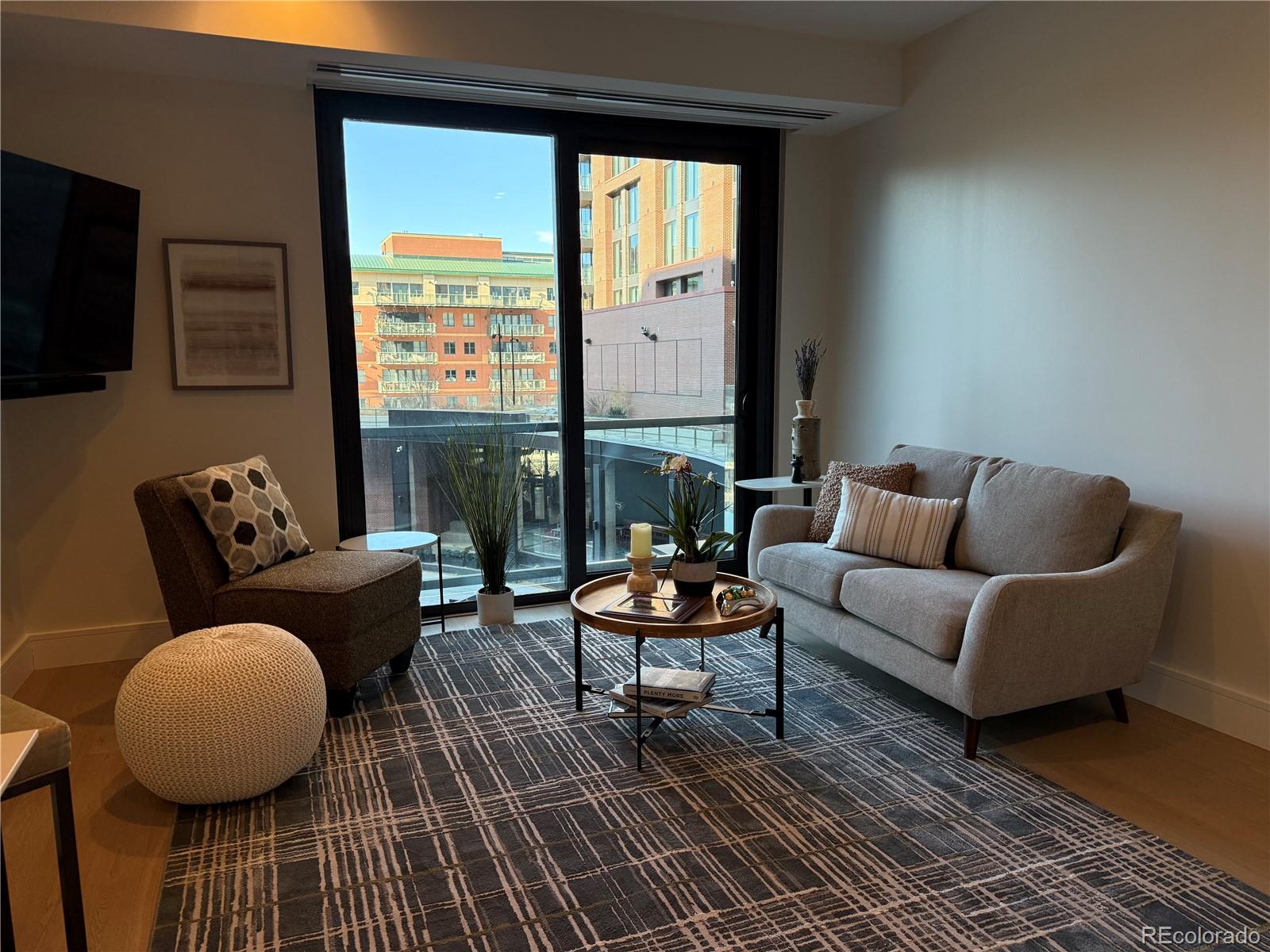 1901 Wazee Street, Unit 412 Denver, CO 80202 - Photo 3 of 33 a living room with furniture and a large window
