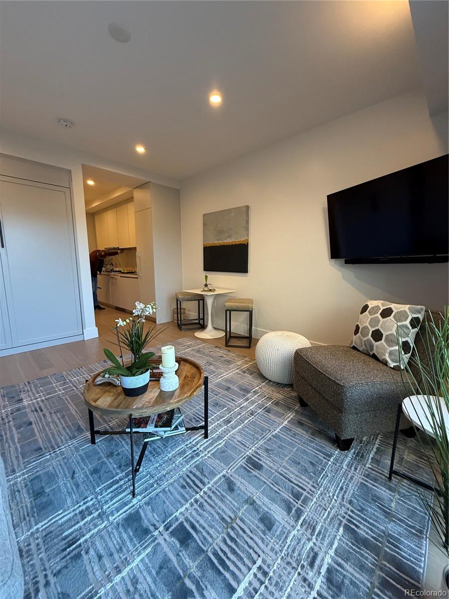 1901 Wazee Street, Unit 412 Denver, CO 80202 - Photo 33 of 33 a living room with furniture and a flat screen tv