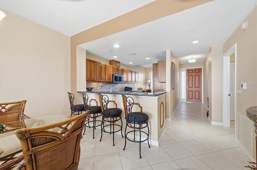 13113 Gasparilla Road, Unit 403 Placida, FL 33946 - Photo 19 of 62 a kitchen with stainless steel appliances kitchen island granite countertop a refrigerator and a stove top oven