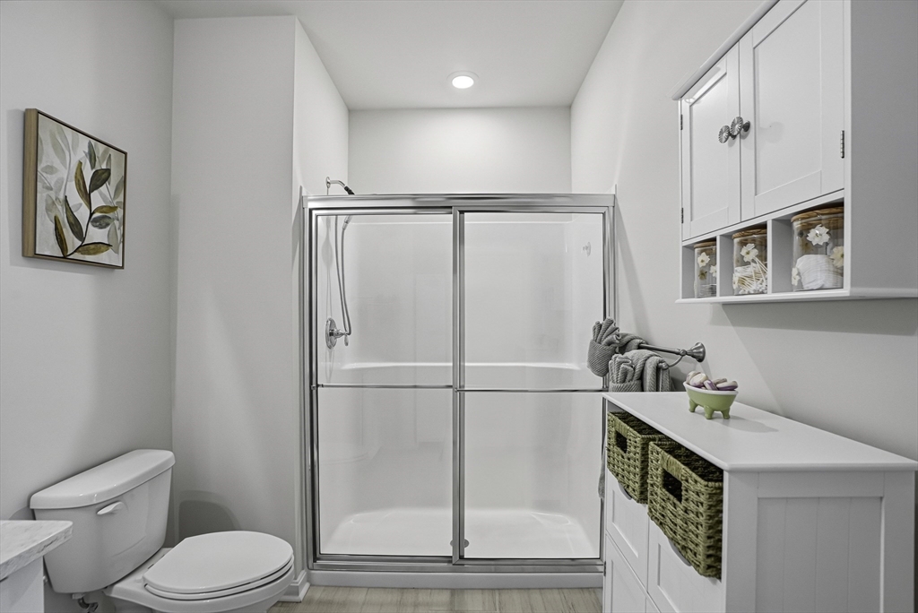 2 Codman Way, Unit 2203 Westborough, MA 01581 - Photo 13 of 36 a bathroom with a toilet a sink and shower
