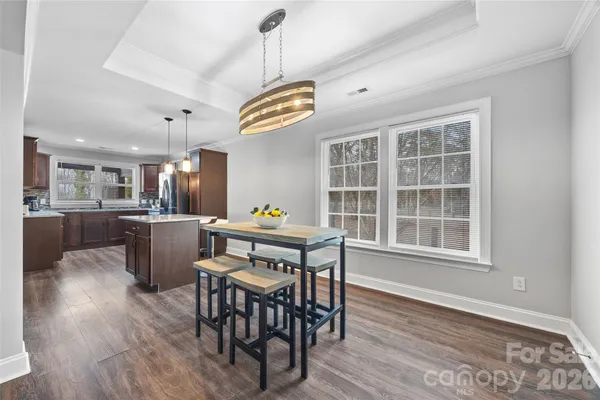 a view of a dining room with furniture wooden floor and chandelier