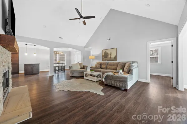 a living room with furniture and a wooden floor
