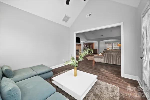 a living room with furniture and wooden floor