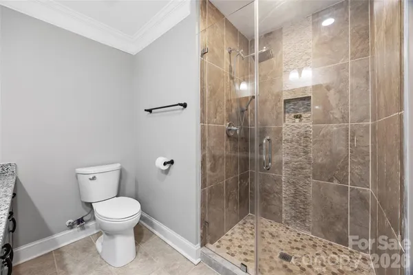 a bathroom with a toilet and a shower