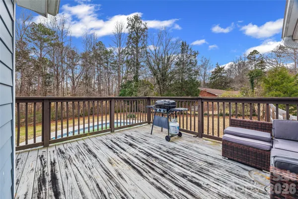 a view of a balcony with wooden floor and fence