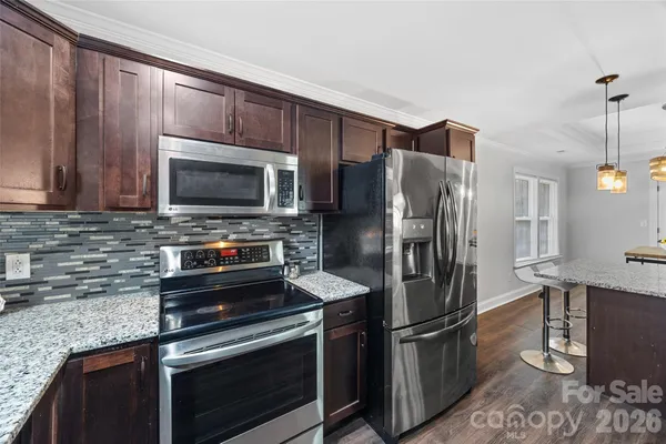 a kitchen with a refrigerator stove and microwave