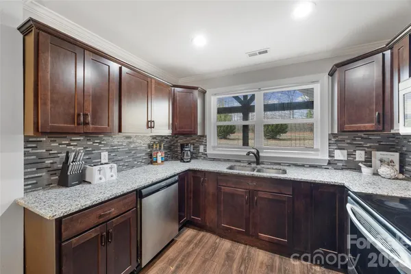 a kitchen with a sink stove and cabinets