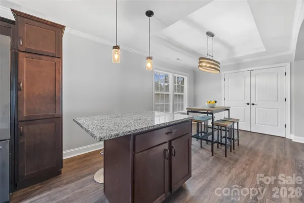 a kitchen with a table and chairs