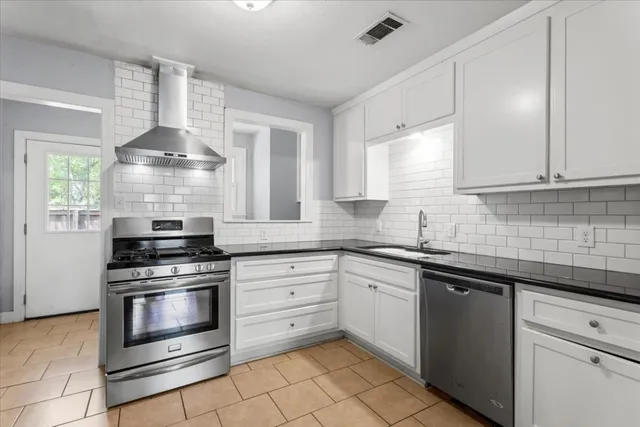 a kitchen with granite countertop a stove and a sink