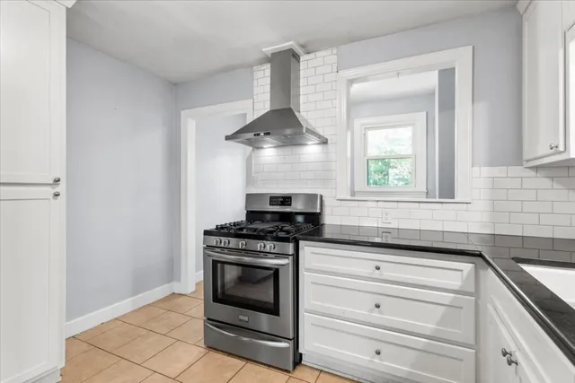a kitchen with granite countertop a stove and a sink