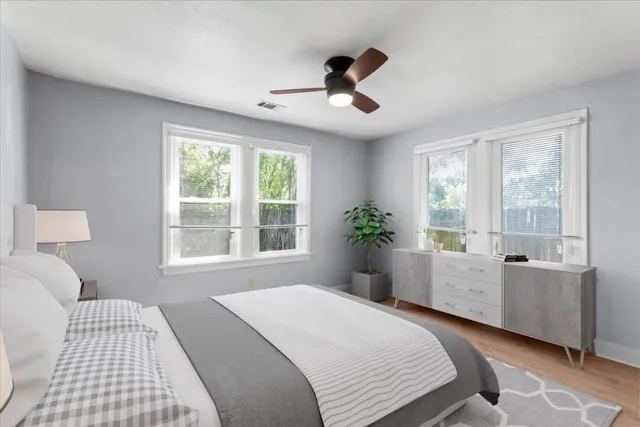 a bed room with a bed and a large window