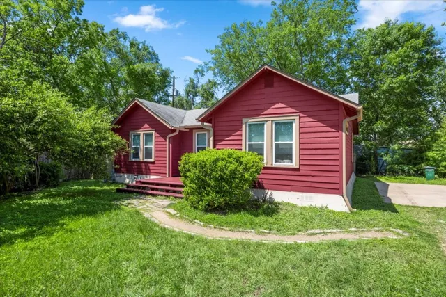 a view of a house with yard and a garden