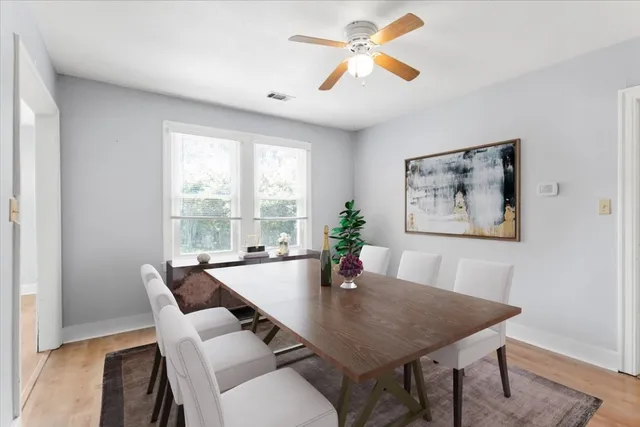a view of a dining room with furniture window and wooden floor