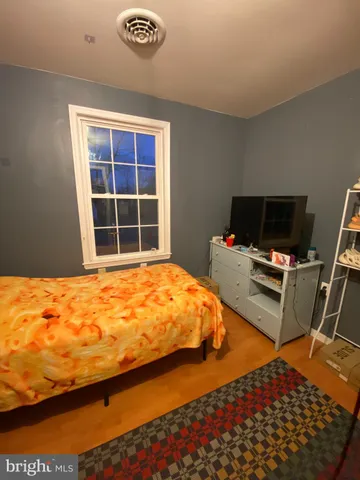 a bedroom with bed and flat screen tv