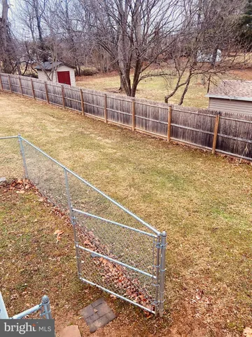 a view of backyard with large trees